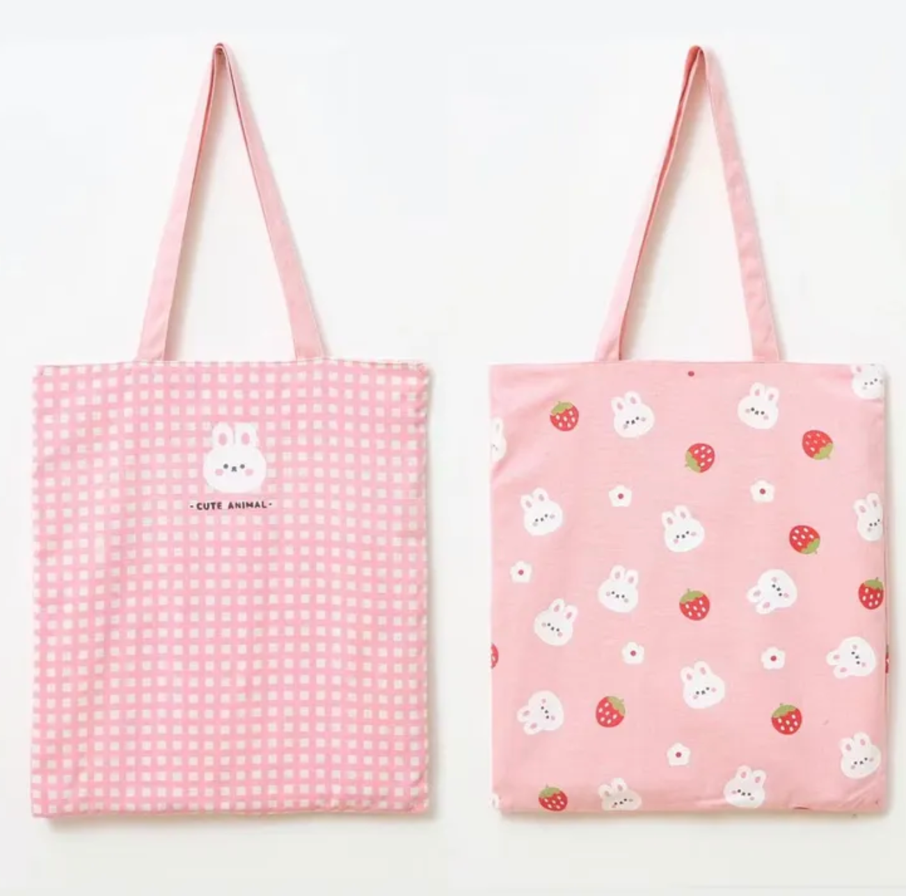 This Pink Gingham Bunny &amp; Strawberry Tote has major cottage-core vibes! This bag is ideal for all your on-the-go tasks and adds a charming kawaii touch to any outfit! Its spacious size makes it perfect for storing laptops, and everyday essentials, or doubling as a handy grocery bag.