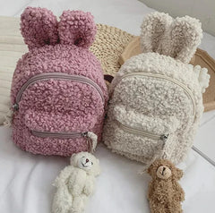 Our Mini Bunny Backpacks in Teddy Plush bring cozy cuteness to your everyday adventures. These adorable mini backpacks are made from super-soft teddy plush material, making them as huggable as they are functional. Each backpack is in the shape of a charming bunny head with pointed ears, giving it a playful look that’s perfect for adding a bit of Kawaii flair to your outfit.