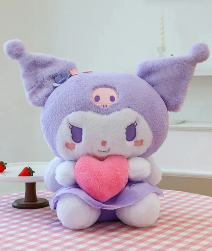 Sassy Kuromi reveals her sweet side in the Angel Wings Huggable Heart Kuromi Plushie! This cutie shows the beloved Sanrio character Kuromi with angelic wings hugging a pink plush heart for a truly charming plush experience. Perfect for cuddles or as a decorative piece.