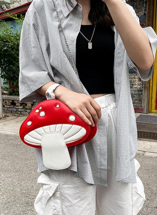 The Red Mushroom Kawaii Street Style Shoulder Bag combines edgy street style with playful design elements, making it the perfect accessory for trendsetters who love a dash of cuteness.

This standout bag features an eye-catching red mushroom design with white polka dots and adorable kawaii-inspired details. The mushroom's cap serves as the bag’s main compartment, complete with a secure zip closure. Carry your essentials while adding a unique woodland flair to any outfit. The detachable chain lets this bag t