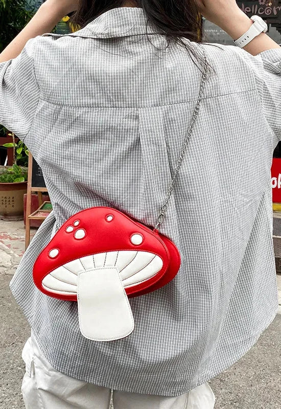 The Red Mushroom Kawaii Street Style Shoulder Bag combines edgy street style with playful design elements, making it the perfect accessory for trendsetters who love a dash of cuteness.

This standout bag features an eye-catching red mushroom design with white polka dots and adorable kawaii-inspired details. The mushroom's cap serves as the bag’s main compartment, complete with a secure zip closure. Carry your essentials while adding a unique woodland flair to any outfit. The detachable chain lets this bag t