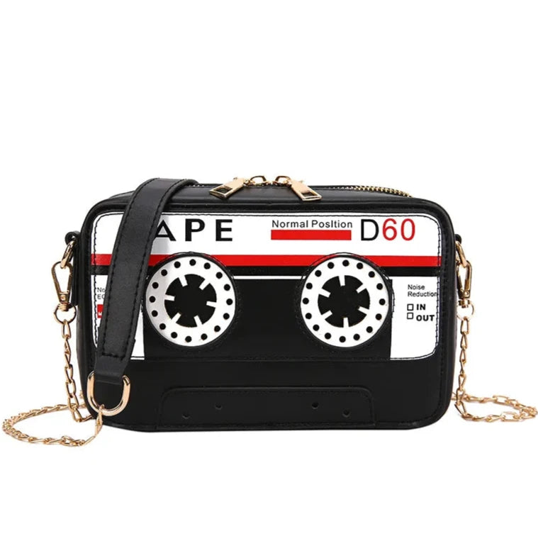 Take your style back in time with but with a fresh kawaii take with our Retro Cassette Tape Kawaii Street Style Black Shoulder Bag. This classy but funky, nostalgic accessory brings the charm of the '80s and '90s into modern-day fashion, combining a fun cassette tape design with streetwear vibes. It's styled to look like a classic cassette tape, complete with vibrant colors, fun graphics, and playful text, making it a perfect tribute to vintage music culture.