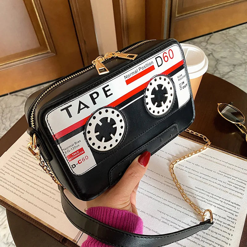 Take your style back in time with but with a fresh kawaii take with our Retro Cassette Tape Kawaii Street Style Black Shoulder Bag. This classy but funky, nostalgic accessory brings the charm of the '80s and '90s into modern-day fashion, combining a fun cassette tape design with streetwear vibes. It's styled to look like a classic cassette tape, complete with vibrant colors, fun graphics, and playful text, making it a perfect tribute to vintage music culture.