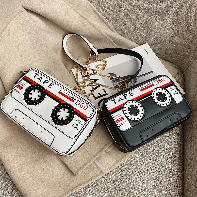 Take your style back in time with but with a fresh kawaii take with our Retro Cassette Tape Kawaii Street Style Black Shoulder Bag. This classy but funky, nostalgic accessory brings the charm of the '80s and '90s into modern-day fashion, combining a fun cassette tape design with streetwear vibes. It's styled to look like a classic cassette tape, complete with vibrant colors, fun graphics, and playful text, making it a perfect tribute to vintage music culture.