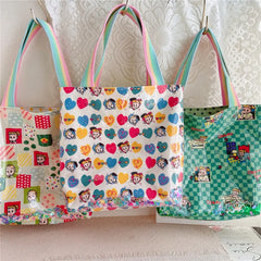 A fabulous mix of Japanese manga and American pop art styles, Japanese illustrator Osamu Harada created some of the most iconic kawaii designs of the 1980s. These Retro Radiance Star Confetti Tote Bags by Osamu Goods feature his wholesome but edgy designs in easy to clean laminated cotton, with unexpected coordinating fabric lining, pastel handles, and a blast of happy star-shaped confetti to top off all this fabulous radiance!&nbsp;