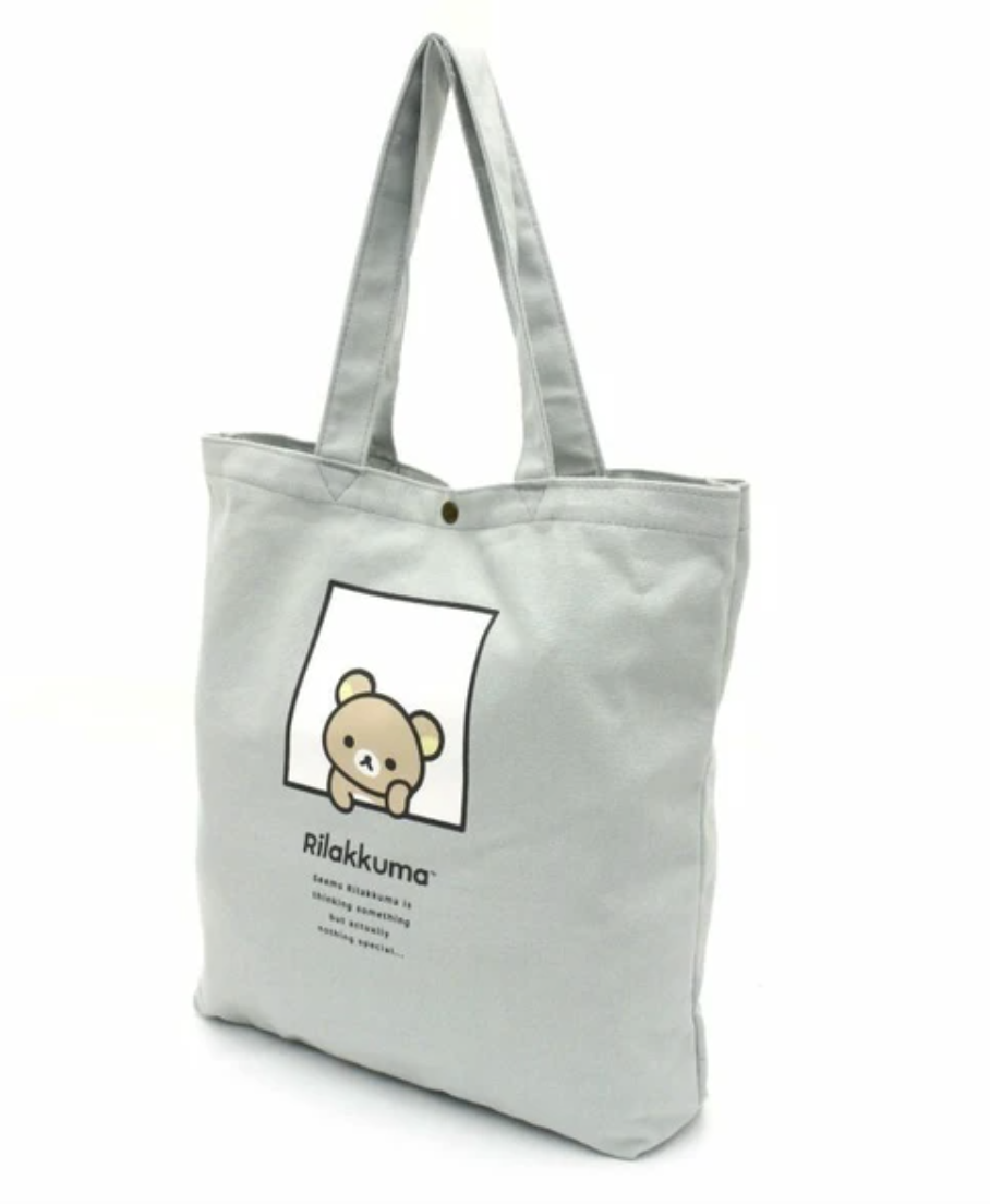 Be the cutest on campus with this adorable and functional Rilakkuma Tote Bag! This light yet durable canvas bag is perfect for shopping, traveling, or just about any adventure.  Its slim design fits snugly under your arm, making it great for commuting to work or school, and its large capacity can easily hold your laptop along with all your school or work essentials. Plus, it features a handy back pocket for extra storage, so you can keep everything organized and within reach.