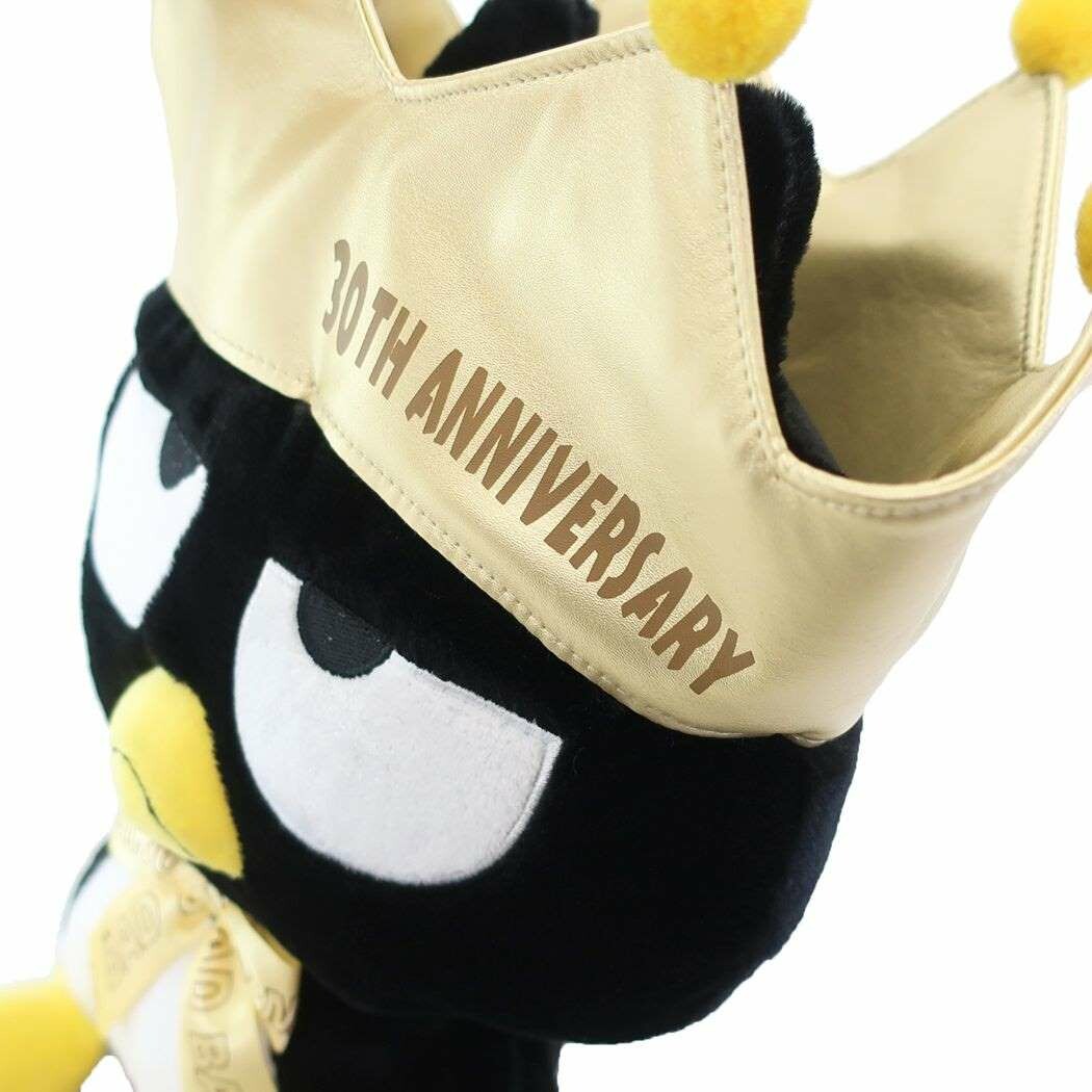 An amazing tribute to one of Sanrio's bad boys, the incomparable Bad Badtz Maru! The King Bad Badtz Maru 30th Anniversary Plushie showcases Badtz in a regal, yet cheeky look befitting his mischievous personality. He sports a well-deserved golden crown and bow tie, making him the true king of attitude.
