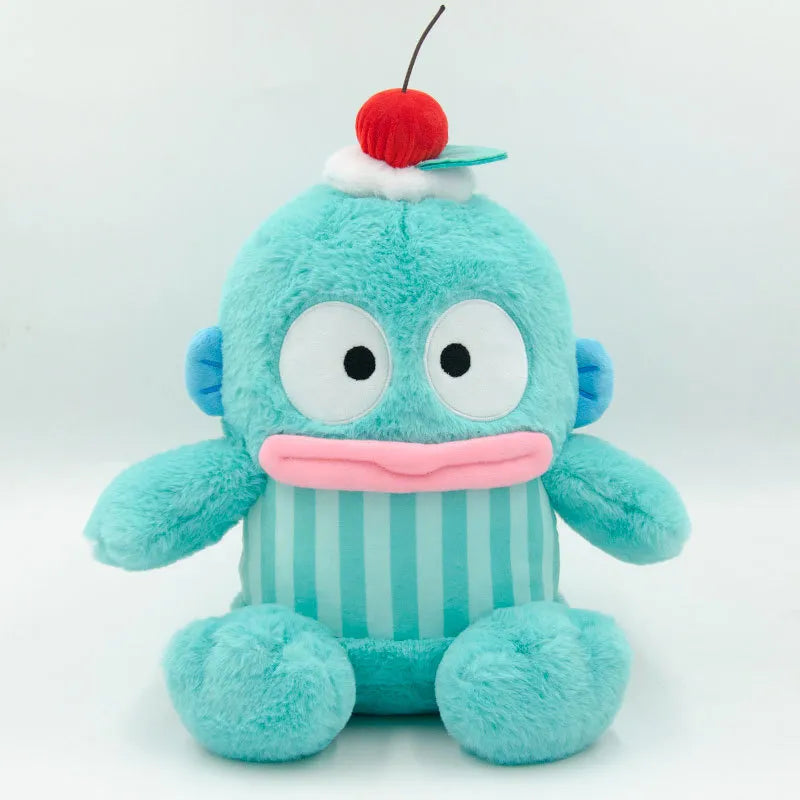 This adorable plushie dons a fruit hat with a dollop of cream and is dressed in a coordinating striped get-up. Bold colors mixed with soft hues add to its cute and cuddly appearance. Hangyodon Cherry Berries n Cream Stuffed Animal by Sanrio