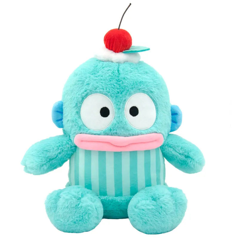 This adorable plushie dons a fruit hat with a dollop of cream and is dressed in a coordinating striped get-up. Bold colors mixed with soft hues add to its cute and cuddly appearance. Hangyodon Cherry Berries n Cream Stuffed Animal by Sanrio