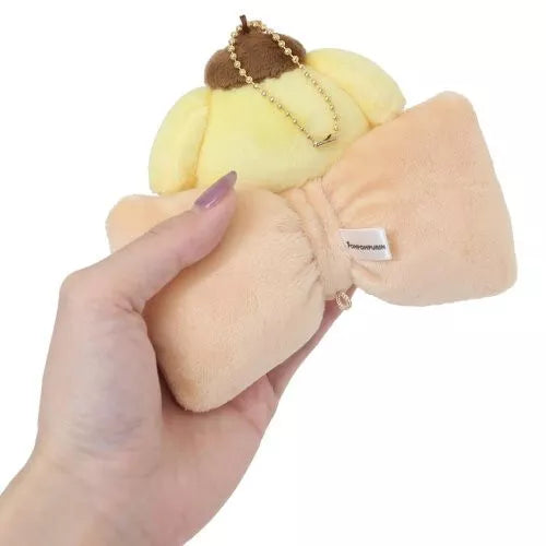 Classic Sanrio characters are featured as their adorable selves, plush style, at the center of a cutie pie bow. The embroidered character name elevates this Big Bow Pompompurin Plush Keychain