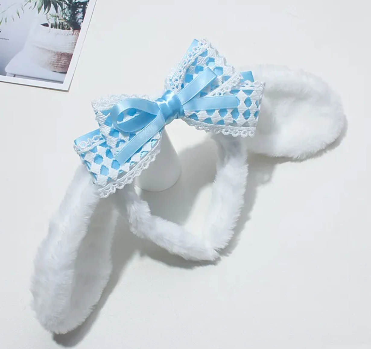 The Cinnamoroll Lace Bow Plush Ears Headband lets you wear your beloved Sanrio character's ears in a soft, plush, huggable way. These spot-on, recognizable ears, fuzzy and white with a specific kind of droop-factor, express kawaii style and Sanrio love simultaneously. Excellent for stylish selfies!