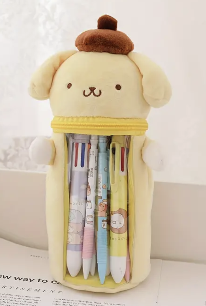 What better way to carry pens and pencils on the go than with these Pompompurin Window Plush Pencil Cases by Sanrio! The cutest of buddies can travel with you, sparking good vibes and maybe even some creativity, with their soft exterior and sweet smiles.  A zip-around neck opening allows for insertion of writing utensils and a transparent window allows for easy viewing. Use this limited edition Sanrio case for storing other small items you’d like to display.