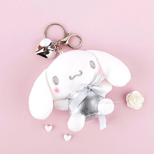 The Silver Glam Cinnamoroll Plush Keychain is a fashion-forward and enchanting accessory that brings a welcomed sparkle to your everyday life. This plush keychain features the beloved Cinnamoroll character, in a two-toned stylish look, made with shimmering silver fabric that adds a glamorous flair.

Made from soft, high-quality materials, it offers a delightful tactile experience while being durable enough for daily use. Its compact size makes it perfect for attaching to keys, bags, or backpacks.