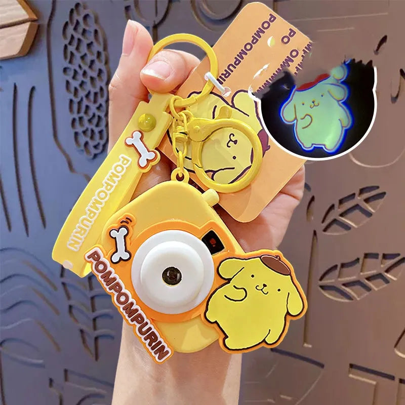 Meet your newest and sweetest party trick! Our Sanrio themed Image Projecting Camera Keychains always bring out the ooohs, ahhhs, and that's sOooOo cute's! This delightful keychain is designed to look like a mini camera and projects an adorable images of a happy kawaii photographer bear, making it a perfect accessory for adding a touch of play to your day. Ideal for kawaii lovers, children, and anyone who enjoys unique and playful accessories.