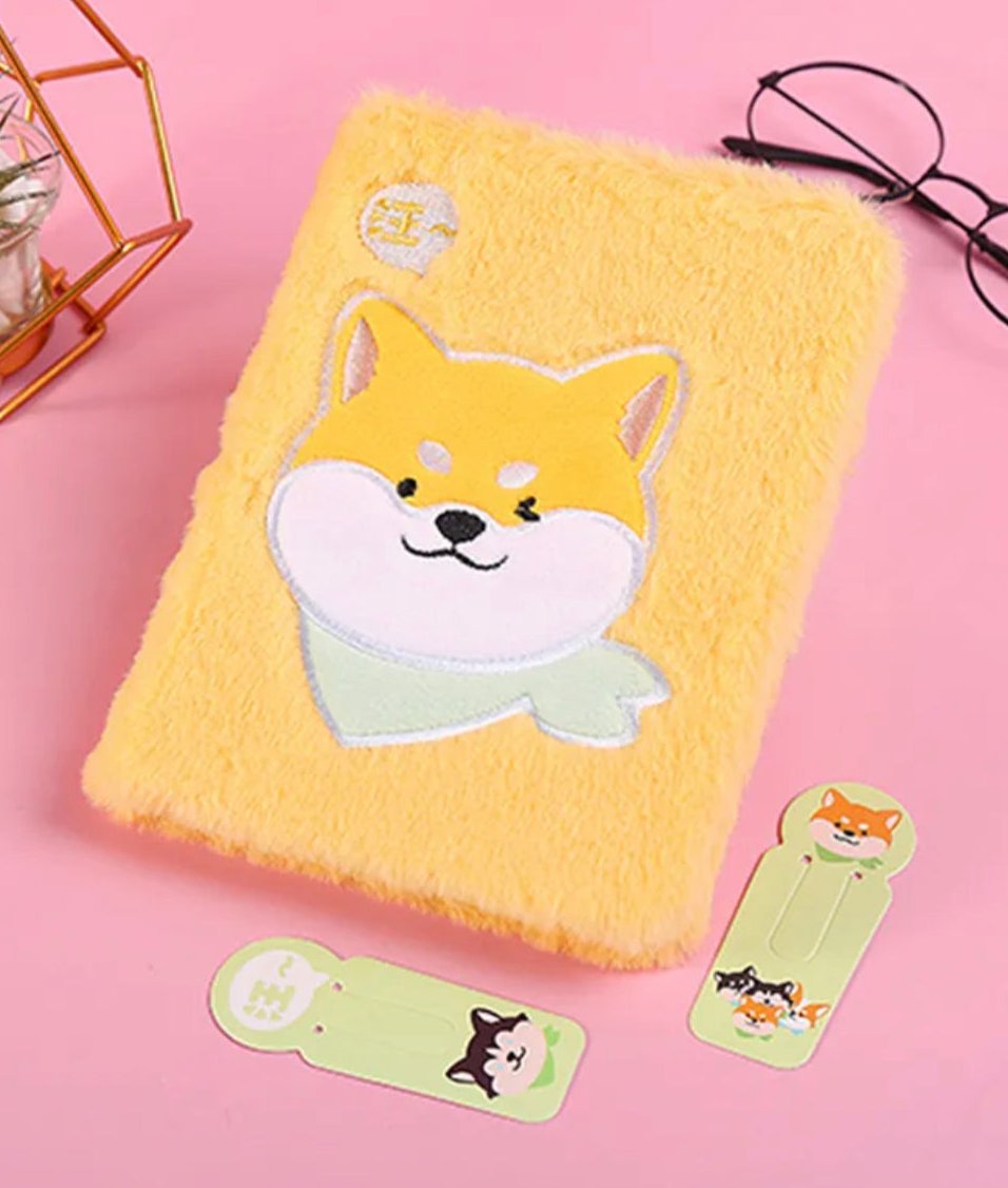 Capture your thoughts, dreams, and ideas in the most adorable way with our Shiba Inu Plushy Journal. Featuring a soft, plush cover designed to look like a cute Shiba Inu in a fabulous little handkerchief, this journal is perfect for dog lovers and anyone who enjoys adding some joy to their stationery collection.