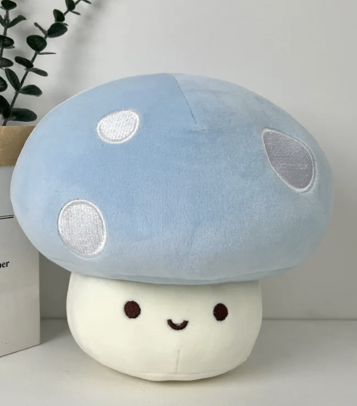 The whimsical Smiling Mushroom Plushie Gang! A vibrant array of adorable fungi companions that will add a pop of color and cheer to any space! Each plush in this collection is lovingly crafted with soft, huggable materials and comes in a variety of bright and playful colors.