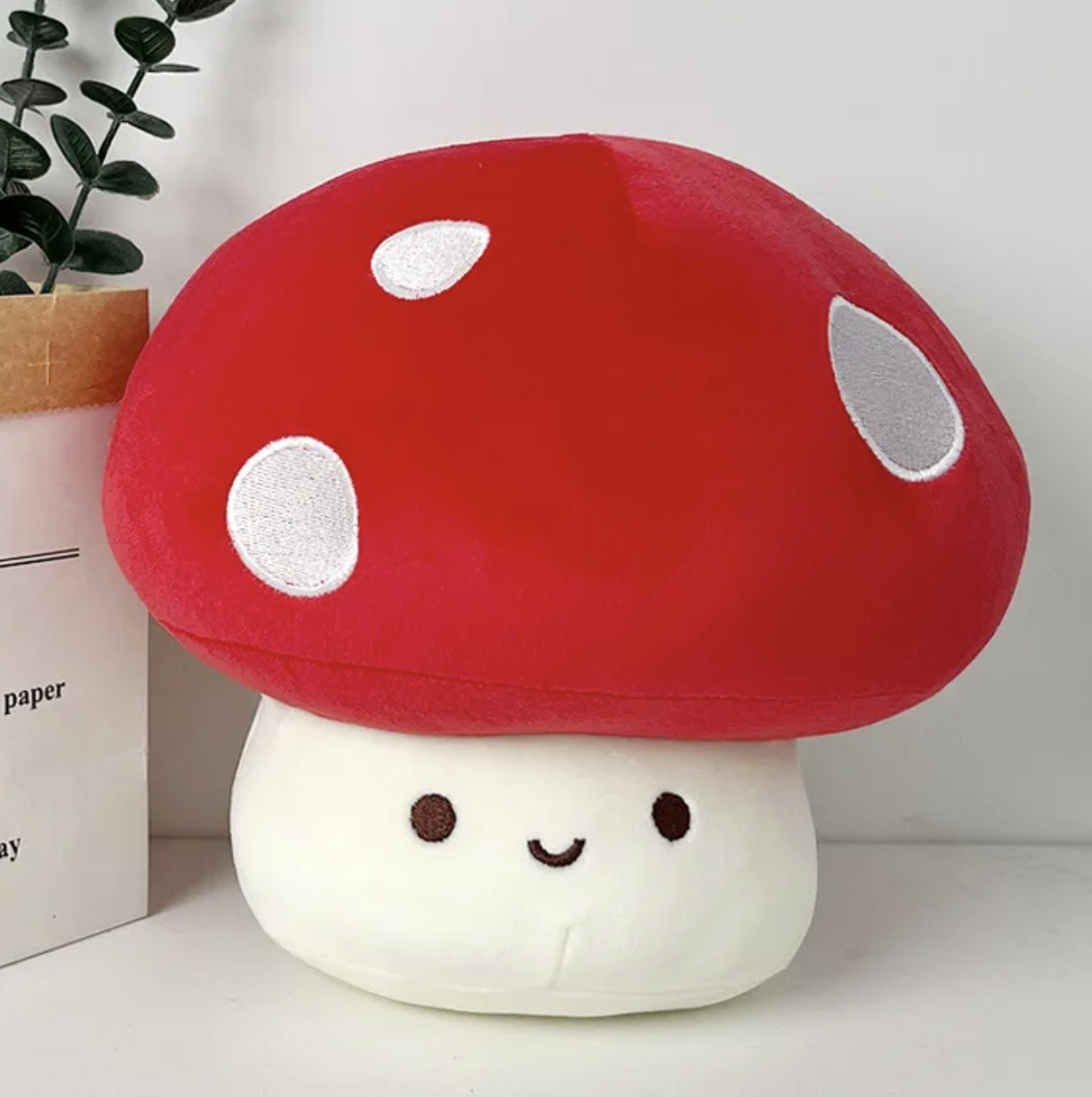 The whimsical Smiling Mushroom Plushie Gang! A vibrant array of adorable fungi companions that will add a pop of color and cheer to any space! Each plush in this collection is lovingly crafted with soft, huggable materials and comes in a variety of bright and playful colors.