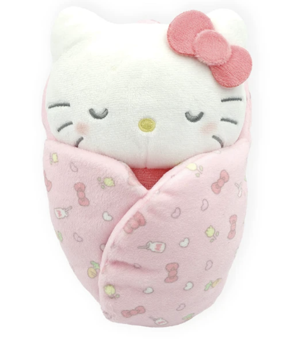 Drift off to dreamland with Sanrio’s Snuggle Baby Hello Kitty in Swaddle Blanket. This swaddled, sleeping cutie with embroidered face is the perfect sleeping companion for kids. Also makes a great gift for a new mom with her own swaddled bundle of joy.