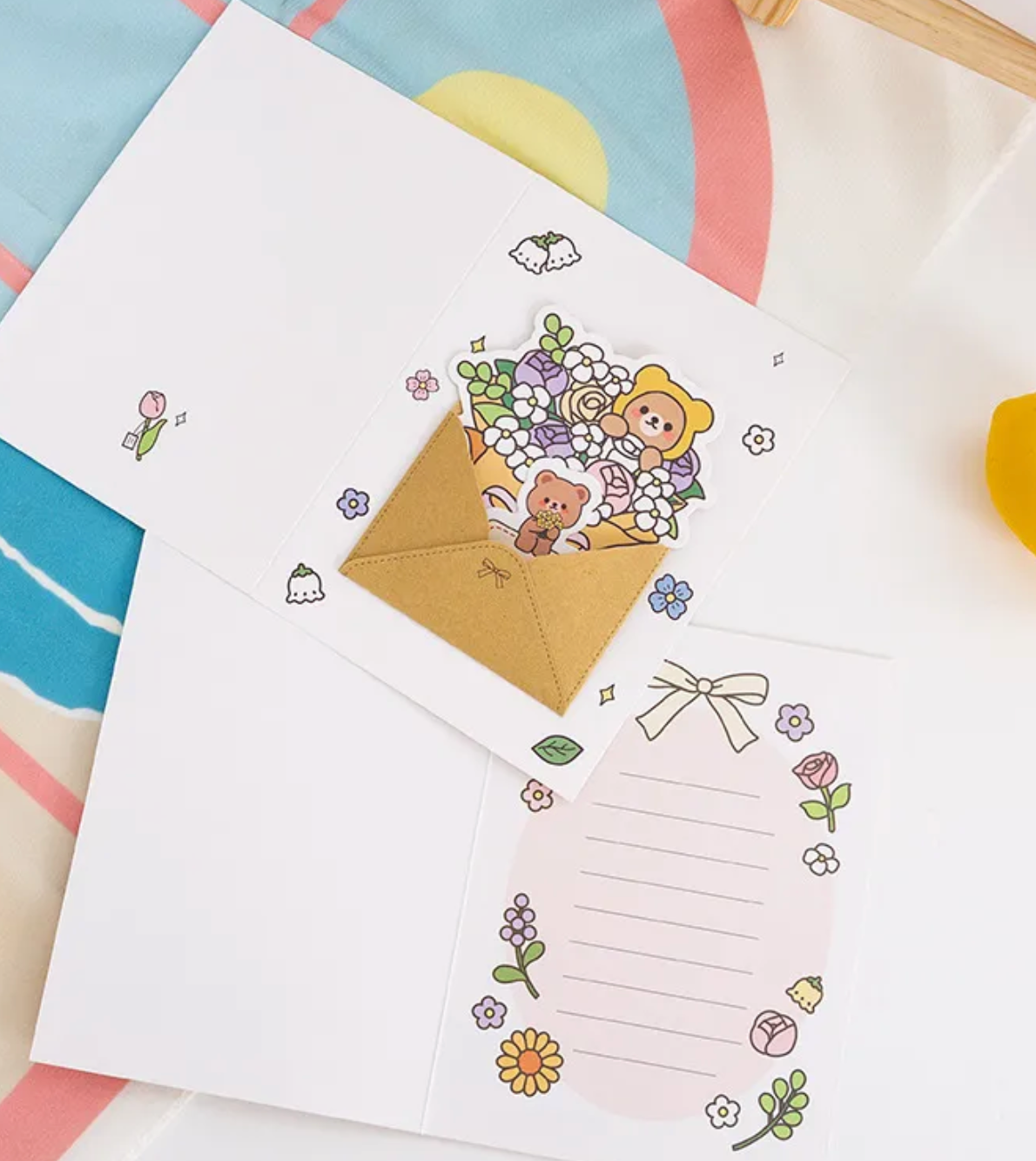 This Spring Bouquet Bear Greeting Card &amp; Bookmark will make greeting loved ones even sweeter! Upon opening the card, the recipient will discover a dainty yet elegant removable bouquet piece and a charming bookmark.