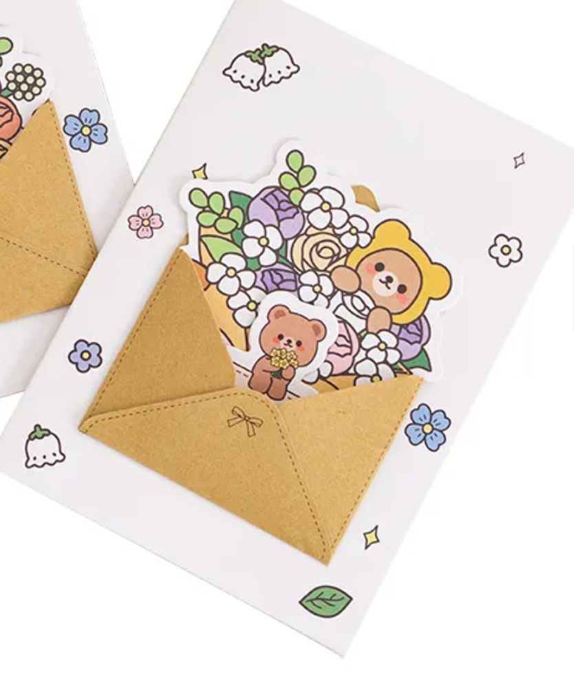 This Spring Bouquet Bear Greeting Card &amp; Bookmark will make greeting loved ones even sweeter! Upon opening the card, the recipient will discover a dainty yet elegant removable bouquet piece and a charming bookmark.