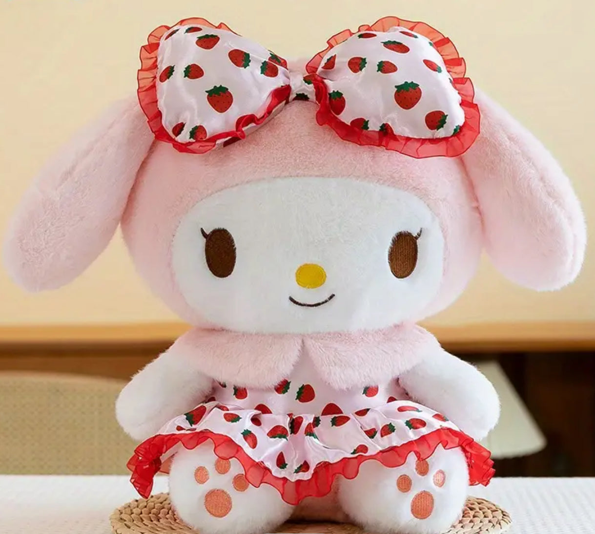 Our delightful Strawberry Fields My Melody Plushie features the Sanrio sweetheart in an adorable strawberry print dress—a delightful blend of mischief and charm! Dressed in a vibrant strawberry print dress adorned with playful bow ruffles, she’s the perfect embodiment of summer whimsy. With her cheeky grin and eye-catching design, this plushie stands out as a unique collectible or a sweet companion.