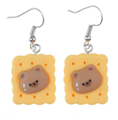 A proper tea biscuit at tea-time never hurt nobody. A round-faced teddy bear never did no harm. Now the two are joining forces to make for an adorable fashion statement.  Tea Time Biscuit Teddy Drop Earrings provide that adorable, funky pop style for the kawaii fashion lovers out there.